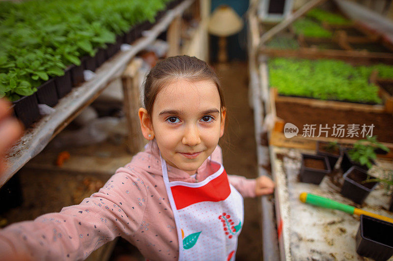 白种人女孩在苗圃/温室工作时互相击掌